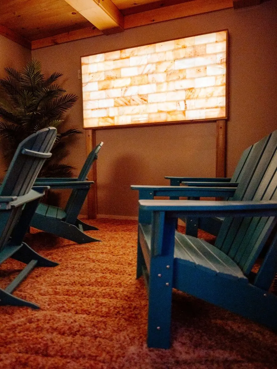 Salt Cabin room with glowing Himalayan salt wall and chairs for stress relief in Stratford