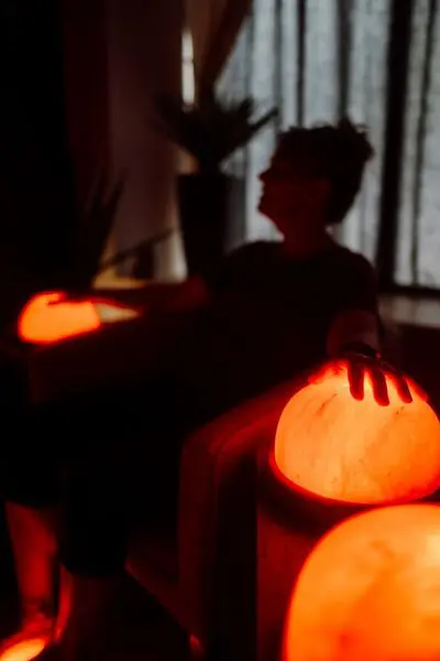 Guest resting with glowing salt stones during a Hand and Foot Salt Detox at The Salt Cabin Wellness Spa in Stratford.