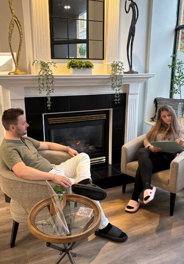 Couple spending quiet time together in the welcoming lounge at The Salt Cabin Wellness Spa in Stratford, Ontario.